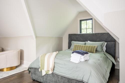a bedroom with a bed with towels on it at Adams Mansion, 10K Sqft, 7BD/7BA, 15min to Airport in Atlanta