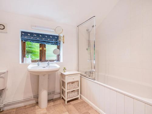 a white bathroom with a sink and a shower at John Fanner Barn - Uk37102 in Mellis