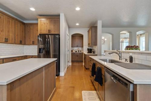 a large kitchen with wooden cabinets and stainless steel appliances at The Dream Home with 5 bedrooms in Meridian ID in Meridian