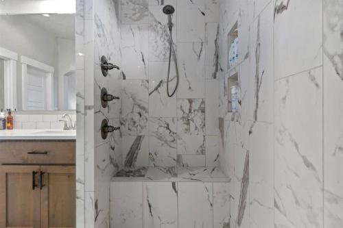a bathroom with a shower with white marble at The Dream Home with 5 bedrooms in Meridian ID in Meridian