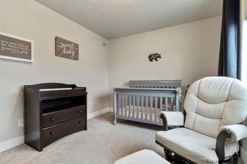 a baby room with a crib and a chair at The Dream Home with 5 bedrooms in Meridian ID in Meridian