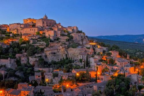 a view of a town on a mountain at night at Appartement+Terrasse en Provence dans le Luberon in Apt