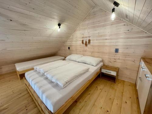 a bedroom with a bed in a wooden room at Sunmare in Sarbinowo