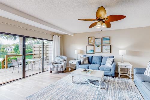 a living room with a blue couch and a ceiling fan at Beachwalk Villa 5194 in Destin