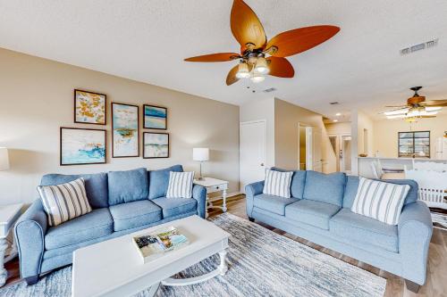 a living room with blue couches and a ceiling fan at Beachwalk Villa 5194 in Destin