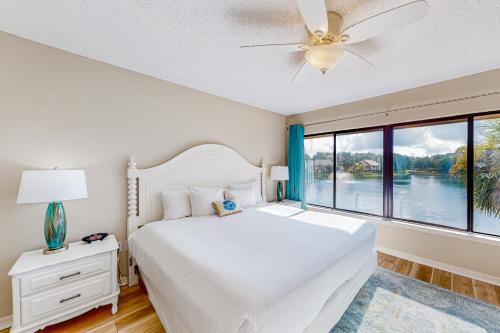 a bedroom with a white bed and a large window at Beachwalk Villa 5194 in Destin