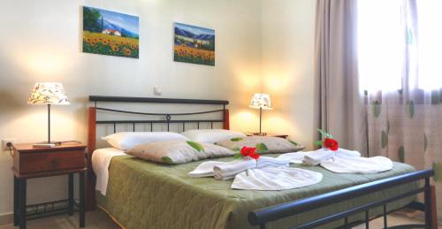 1 dormitorio con 1 cama con toallas en ANEMOESSA APTS en Livadia