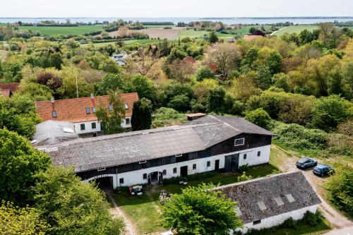 an aerial view of a white barn with trees at Højriisgaard B & B in Nørreby