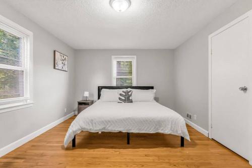 a white bedroom with a bed and a window at North Haven Charm, 3BD Yale Retreat in North Haven
