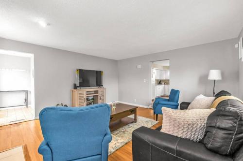 a living room with a couch and blue chairs at North Haven Charm, 3BD Yale Retreat in North Haven