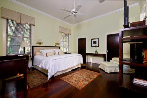 a bedroom with a bed and a ceiling fan at Rhett House in Beaufort