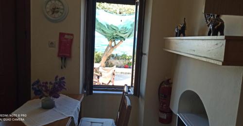 a kitchen with a table and a window with a view at ANEMOESSA APTS in Livadia