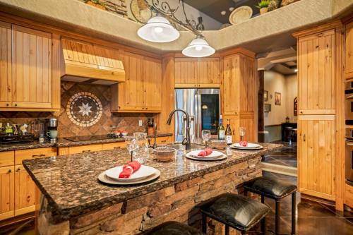 a kitchen with wooden cabinets and a stone counter top at Quail Mountain Desert Resort: Heated Pool, Mt Vews, all BR's King & TV's, Hiking in Mesa