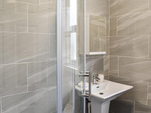 a bathroom with a sink and a shower at Henry House in Blackpool