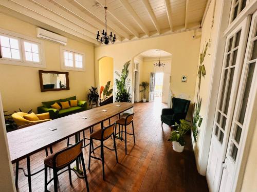 a living room with a large wooden table and chairs at Ancestral Hostel Barranco in Lima