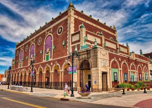 a large brick building on the corner of a street at The Stockton - Victorian Ocean Grove near Asbury in Ocean Grove