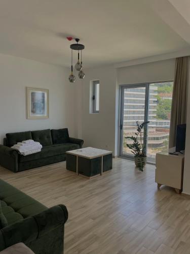a living room with a couch and a table at Hotel Kaligrosh in Sutomore