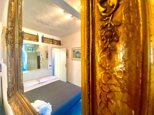a bedroom with a mirror and a bed in a room at Casa Ignazia in Taormina