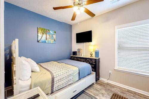 a bedroom with a bed and a ceiling fan at Palm Tree Paradise in Myrtle Beach