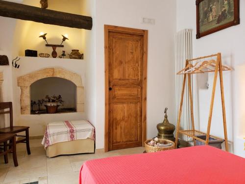 a room with a fireplace and a wooden door at Casa Santa Chiara - Affitti Brevi Italia in Monte SantʼAngelo