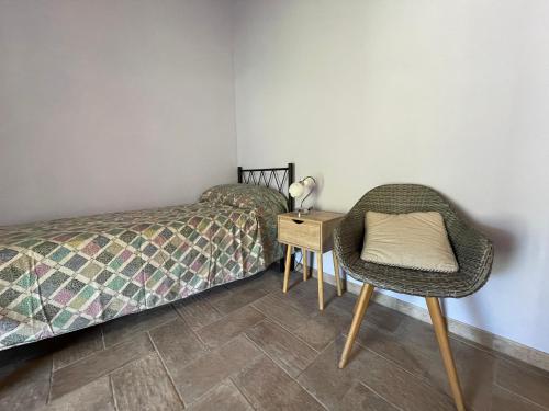 a bedroom with two beds and a table and a chair at Le Gatte in SantʼUrbano
