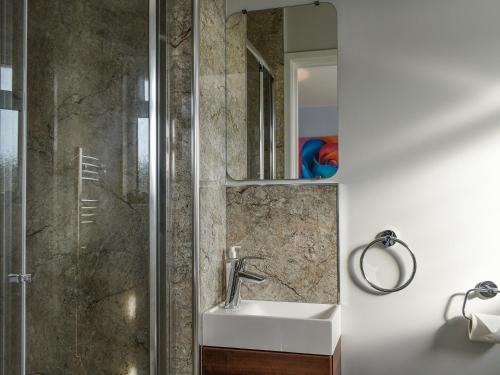 a bathroom with a sink and a shower at Markham House in Radipole