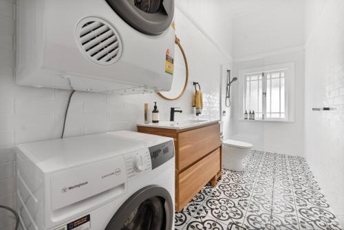 a laundry room with a washer and dryer in it at The Bank House Ulmarra in Ulmarra