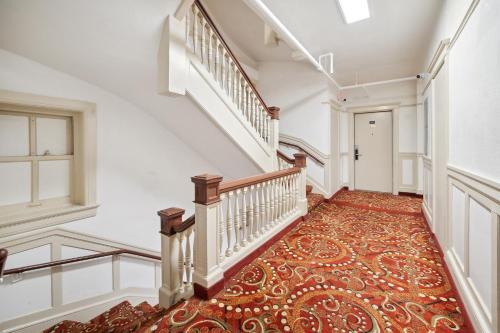 an empty hallway with stairs and a carpeted floor at Union Square Plaza Hotel in San Francisco