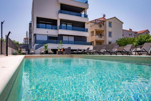 a swimming pool in front of a building at KM Exclusive Apartments in Zadar