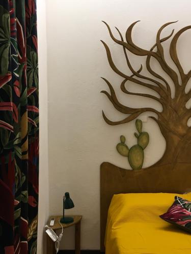 a bedroom with a bed with a deer head on the wall at Agrolea in Terme Vigliatore
