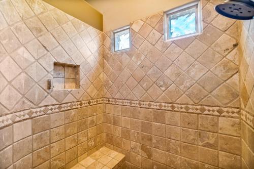 a tiled shower with two windows in a bathroom at Quail Mountain Desert Resort: Heated Pool, Mt Vews, all BR's King & TV's, Hiking in Mesa