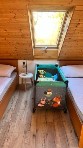 a small bedroom with two beds and a window at SnežienkaD in Smokovce