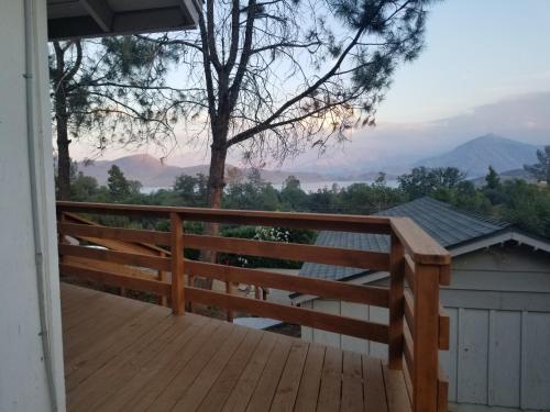 a wooden deck with a view of the mountains at 3BR Panoramic Lake View, Sequoia Forest, Kern County in Wofford Heights