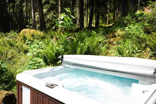 a bath tub in the middle of a forest at ArborMyst in Glacier