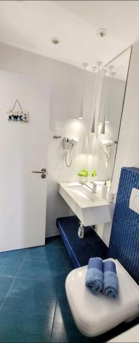 a bathroom with a sink and a toilet and a mirror at SUN SEA No 5 sea view in Perea