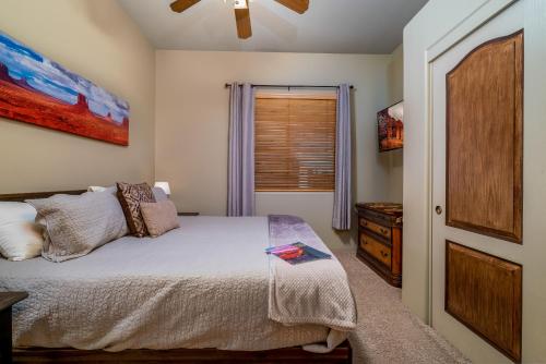 a bedroom with a bed and a window at Quail Mountain Desert Resort: Heated Pool, Mt Vews, all BR's King & TV's, Hiking in Mesa