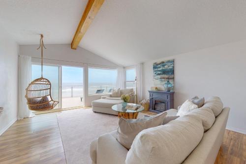 a living room with a couch and a table at Salty Shore in Rockaway Beach