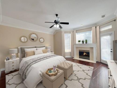 a bedroom with a large bed and a fireplace at Convenient location in upscale city of Southlake. in Southlake