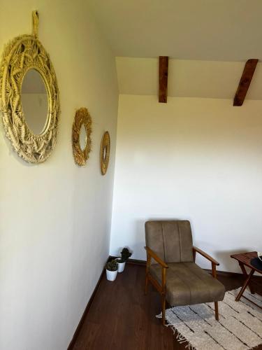 a room with a chair and a mirror on the wall at Fruskogorski mir in Besenovacki Prnjavor