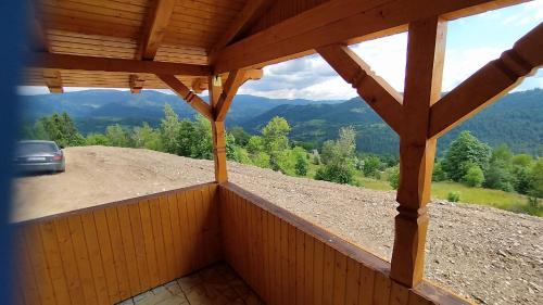 a view from the inside of a porch with a car on a mountain at Cabana Trif in Horea