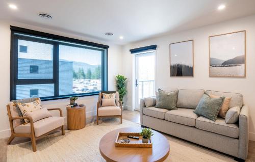 a living room with a couch and two chairs at Stoked On Revy - Family Condo in Revelstoke in Revelstoke