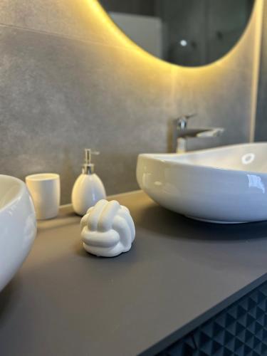 a bathroom counter with a sink and a white bowl at AURUS in Korčula
