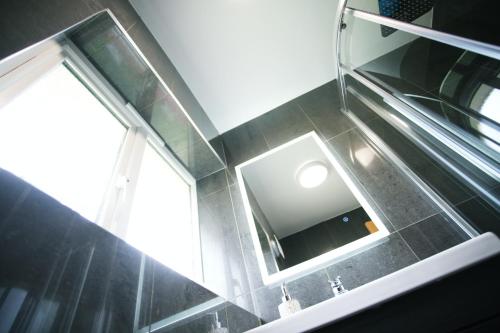 a bathroom with a mirror and a sink at Tree View Apartment in Chesterton