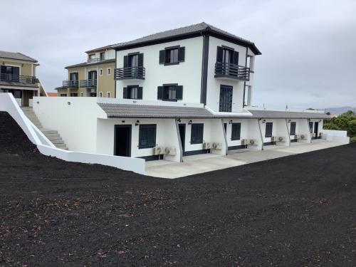 a large white building with a ramp in front of it at Villa Da Madalena in Madalena