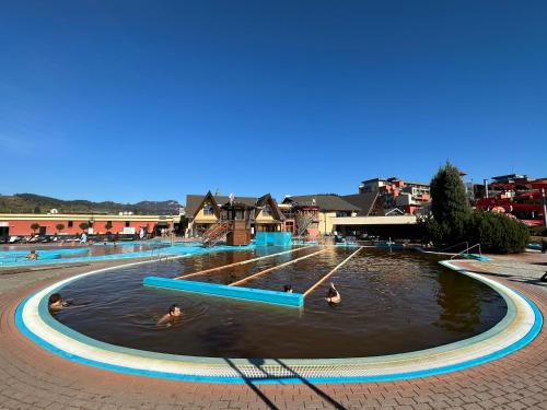 a pool with people swimming in the water at Apartmán Bešeňová 289 in Bešeňová