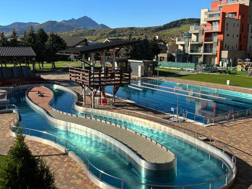 a large swimming pool in a city at Apartmán Bešeňová 289 in Bešeňová