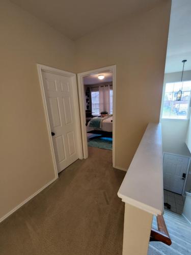 an empty room with a door leading to a bedroom at D & J ESTATE in Killeen