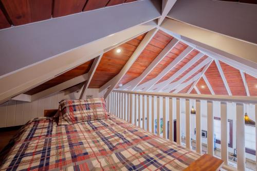 a loft bed in a room with a wooden ceiling at Caribbean Vacation Rentals and The PoolClub at Mahogany! in San Pedro