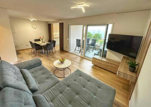 a living room with a couch and a tv and a table at Luxury and Spa App F in Makarska