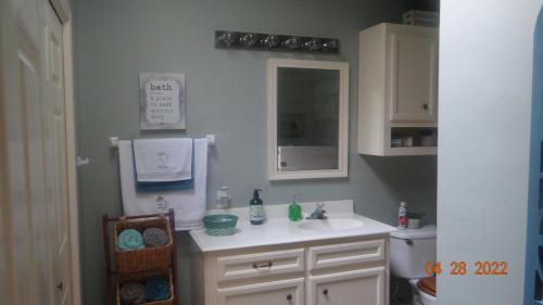 a bathroom with a white sink and a mirror at Joyful Quarters - Beautiful Spacious 1 Bedroom Apt in Houston